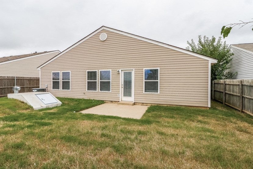 the backyard of a house with a yard and a deck