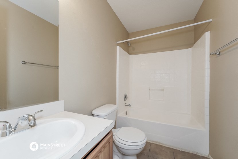 a bathroom with a sink and a toilet and a shower