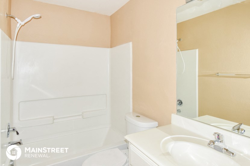 a bathroom with a sink and a toilet and a shower