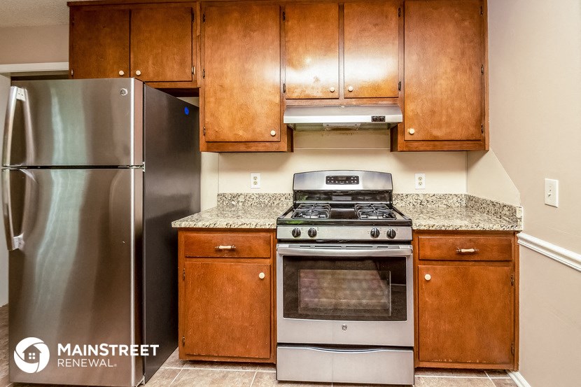 a kitchen with stainless steel appliances and wooden cabinets