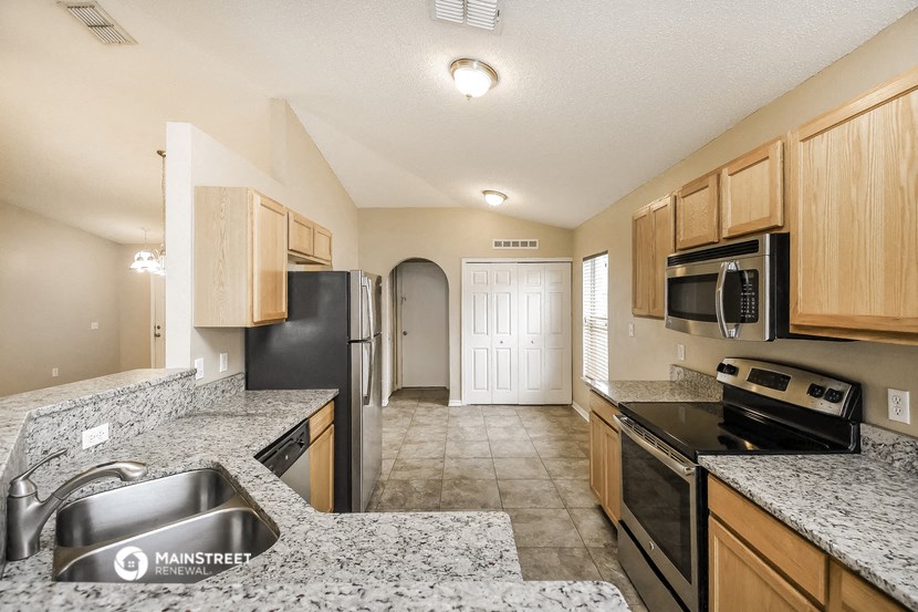 a kitchen with granite counter tops and black appliances