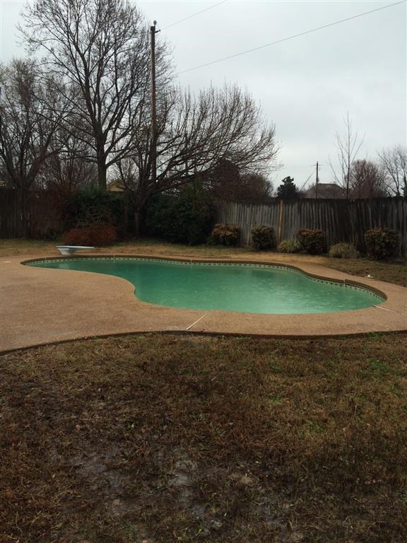 a swimming pool in the middle of a yard
