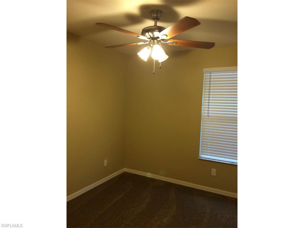a bedroom with a ceiling fan and a window