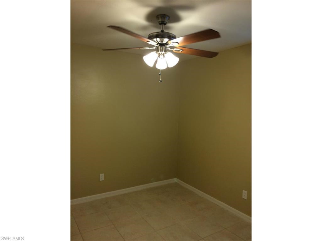 an empty room with a ceiling fan