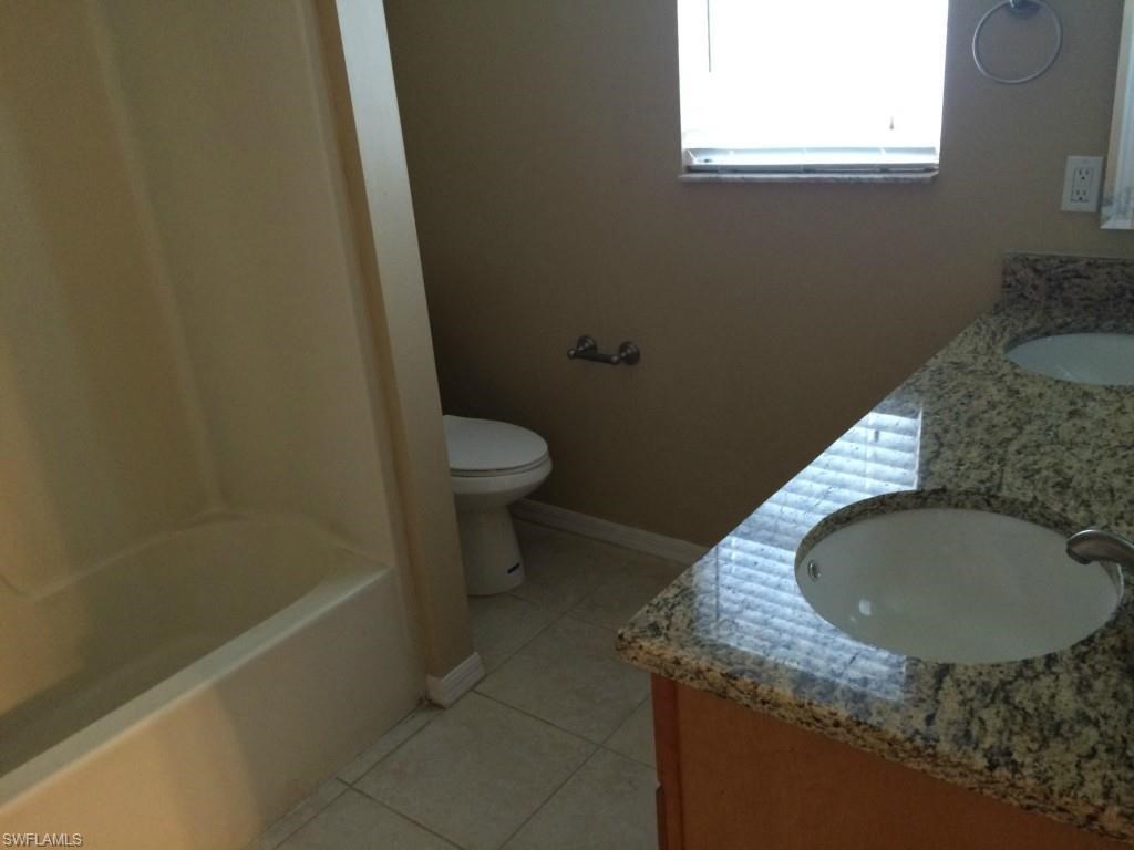 a bathroom with a sink and a toilet and a bath tub