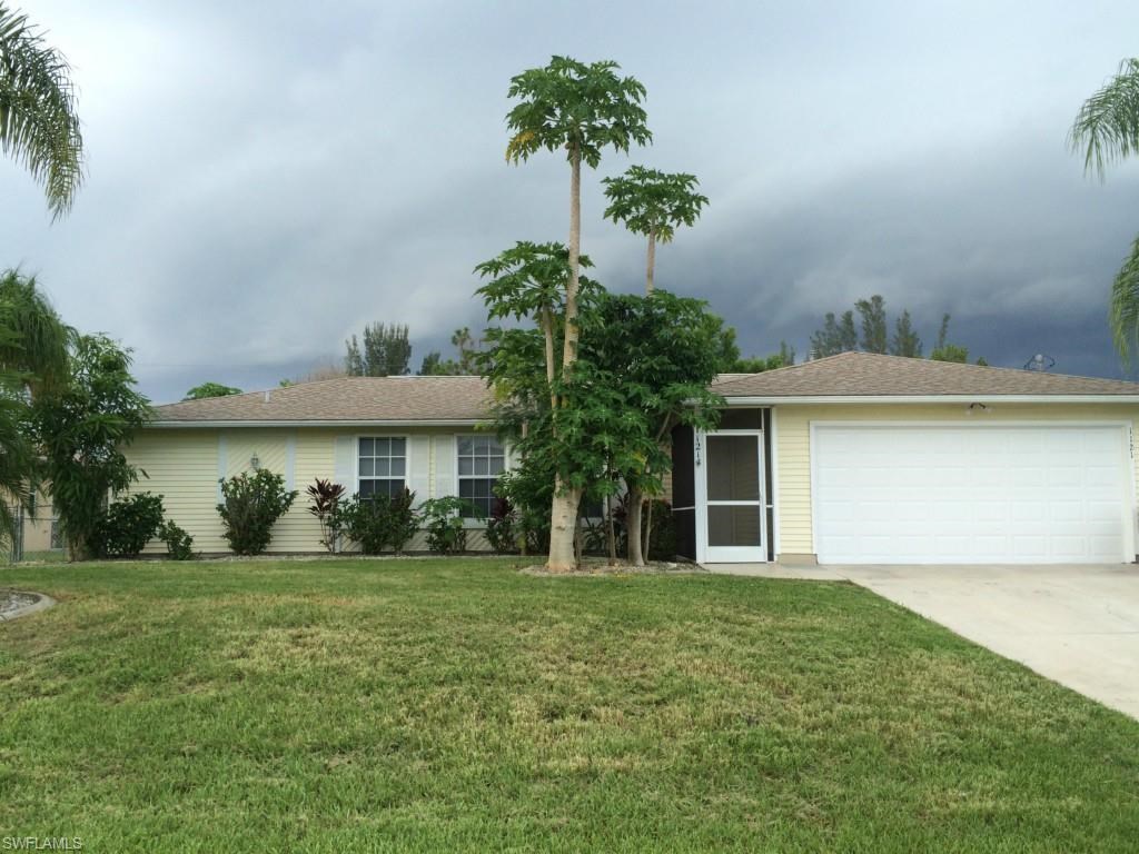 a white house with palm trees in front of it