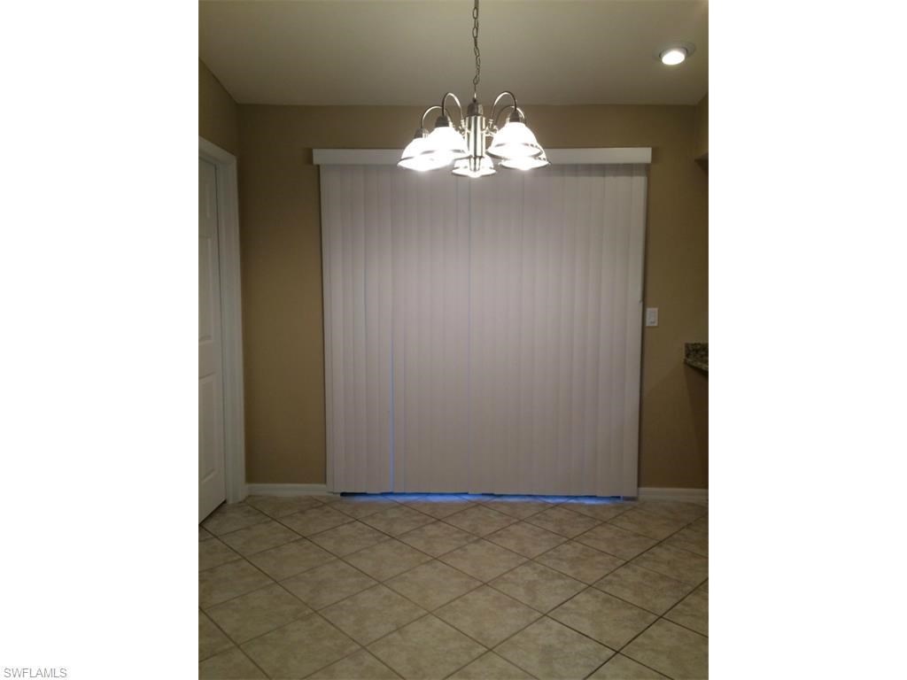 an empty living room with a sliding glass door