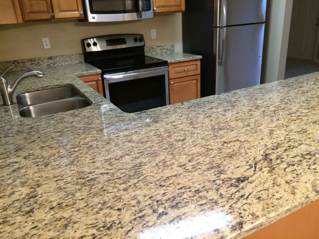 a kitchen with a granite counter top and a sink