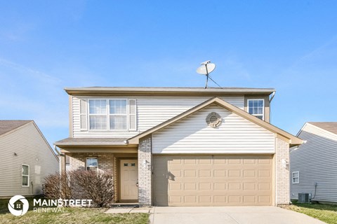 a home with a garage door and a satellite dish on top of it