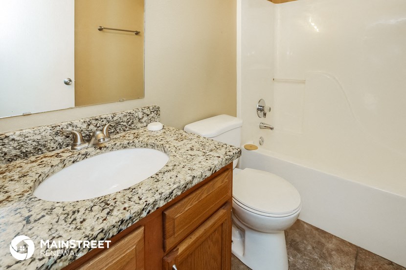 a bathroom with a sink and a toilet and a bath tub