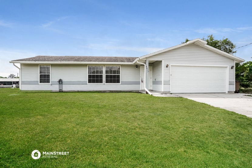 a white house with a lawn in front of it