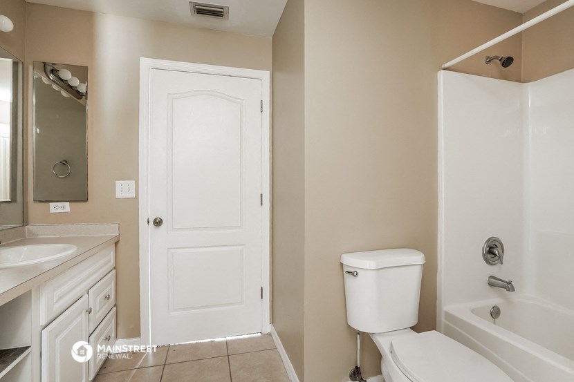 a bathroom with a toilet and a sink and a shower