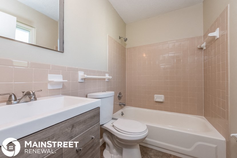 a bathroom with a sink toilet and a bath tub