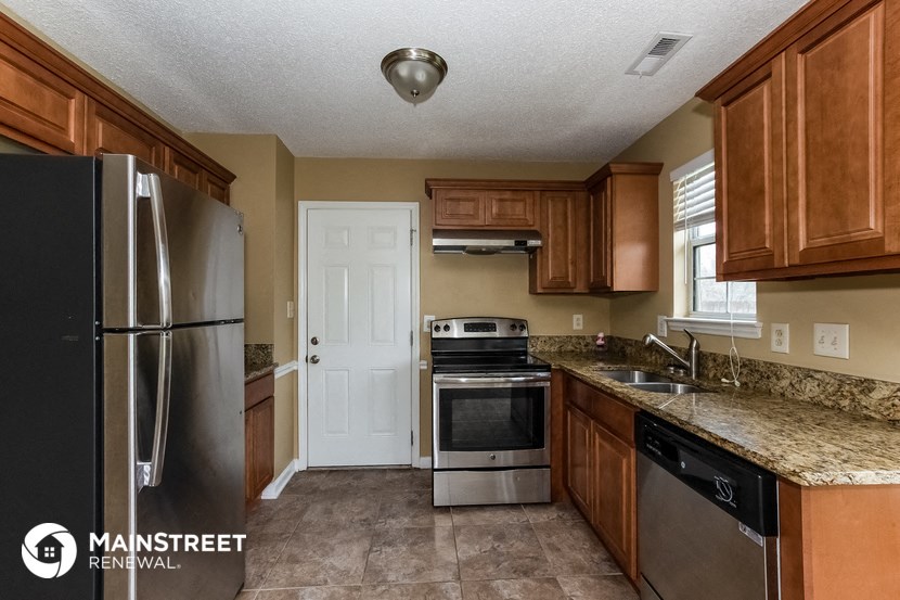 a kitchen with wood cabinets and stainless steel appliances and granite counter tops