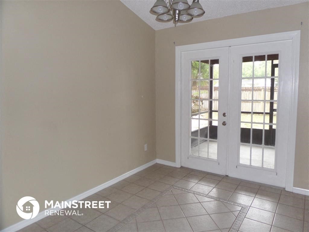 an empty living room with a door to a patio
