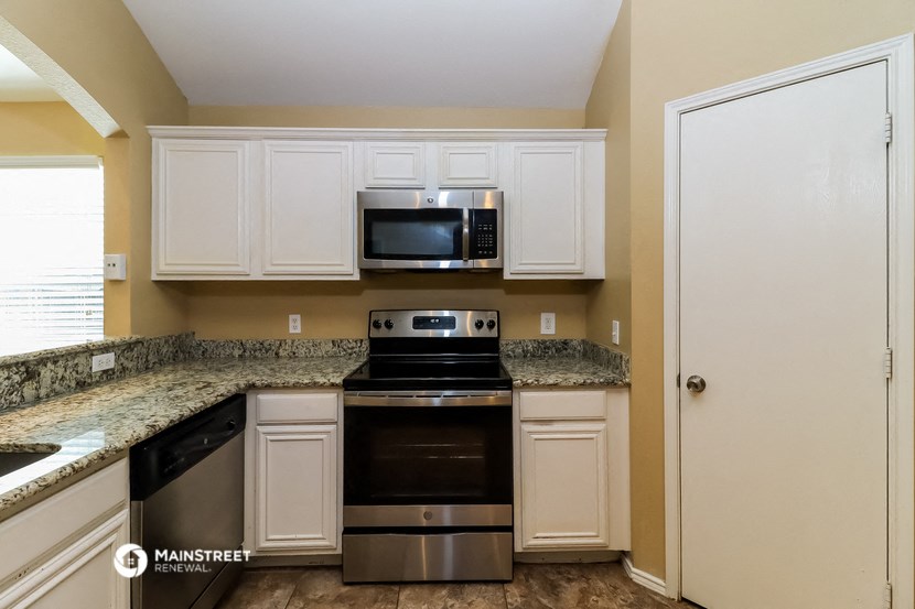 a kitchen with stainless steel appliances and granite counter tops