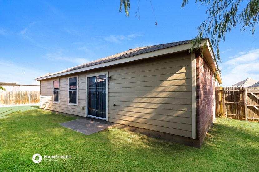 a small house with a garage in a backyard