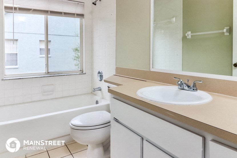 a bathroom with a sink and a toilet and a tub