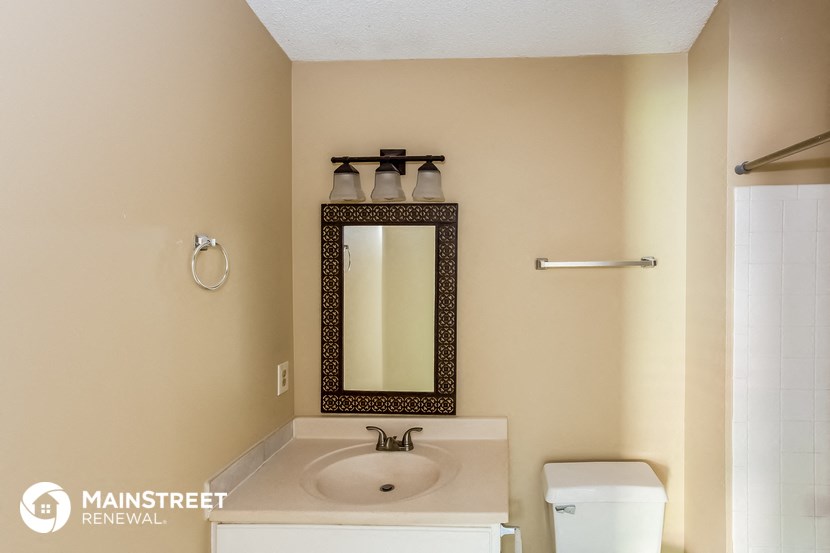 a bathroom with a sink and a mirror and a toilet
