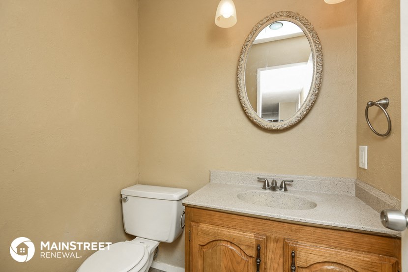 a bathroom with a toilet sink and a mirror