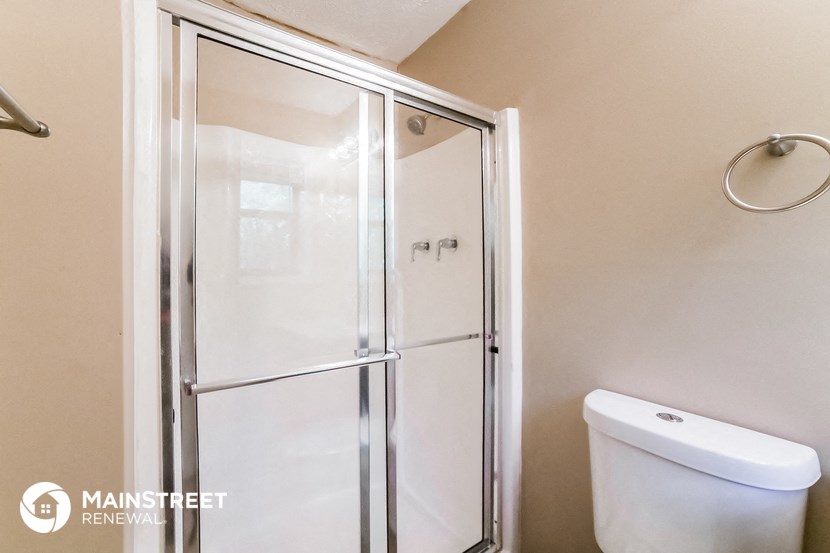 a small bathroom with a shower and a toilet