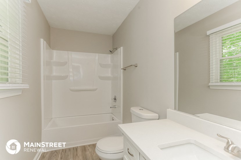 a bathroom with a shower and a sink and a toilet