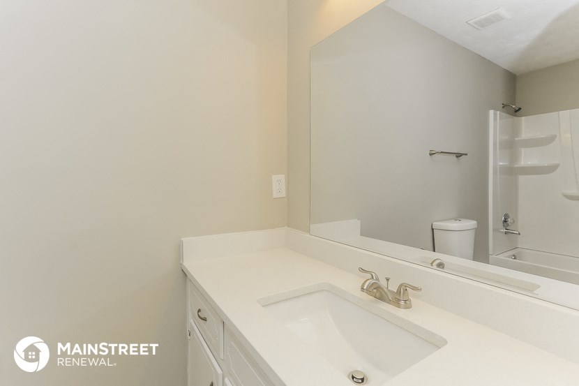 a bathroom with a sink and a mirror and a shower