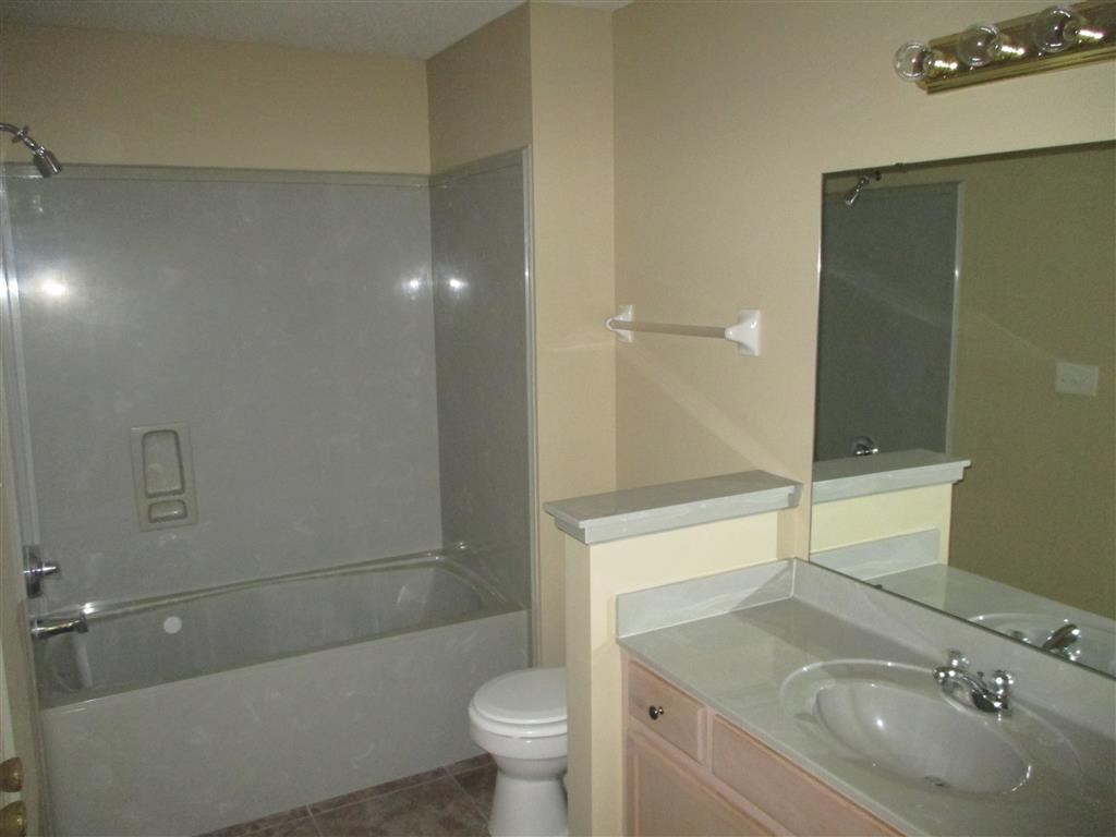 a bathroom with a sink toilet and a shower