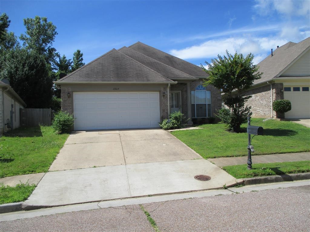 a house with a driveway and a white garage door