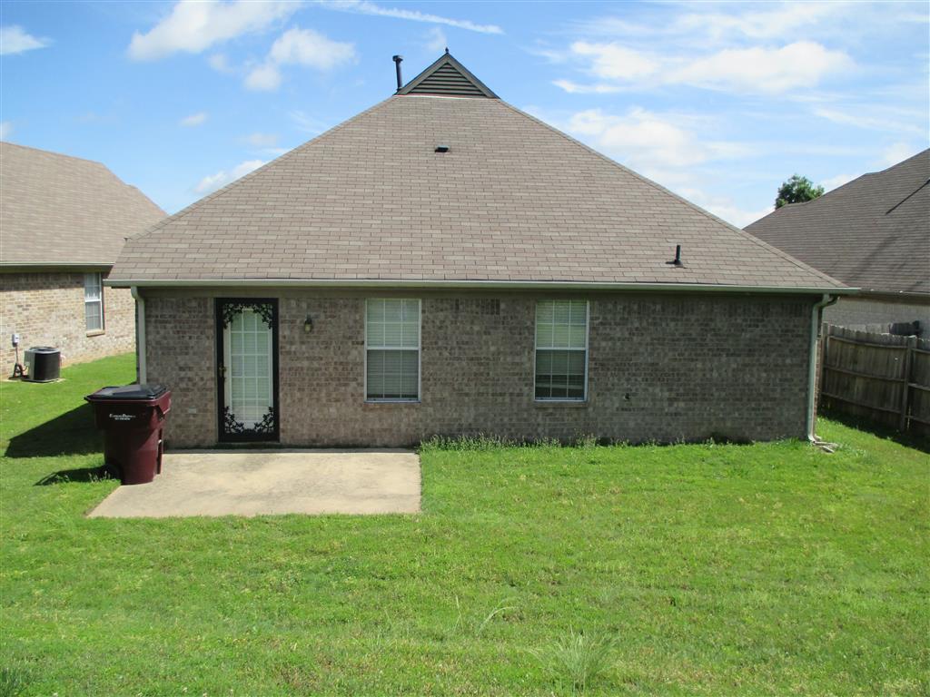 a house with a roof and a yard