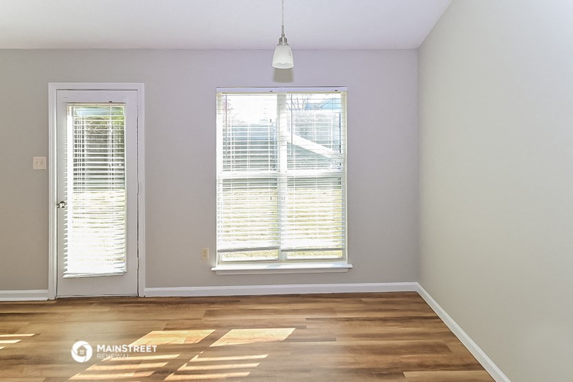 an empty room with a window and a door