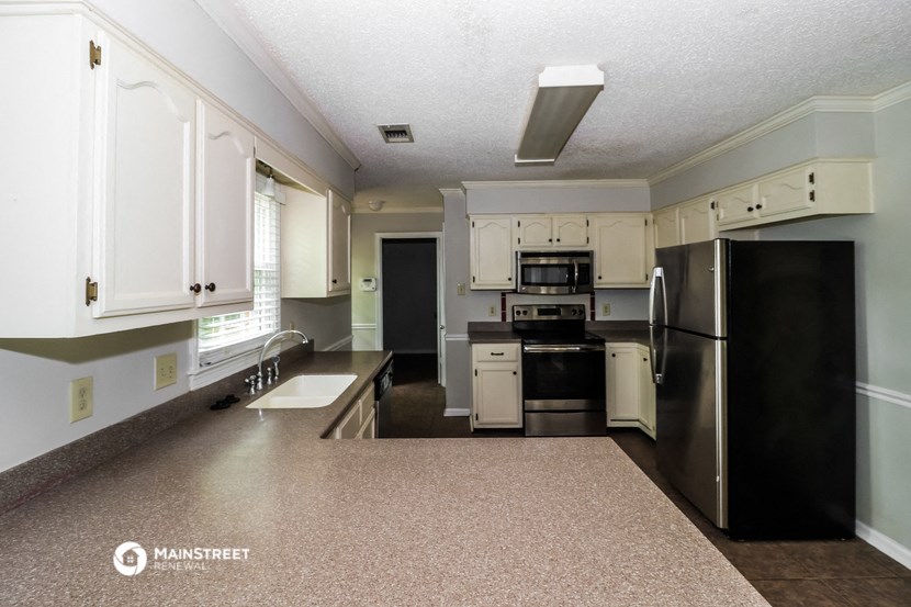 a kitchen with stainless steel appliances and white cabinets