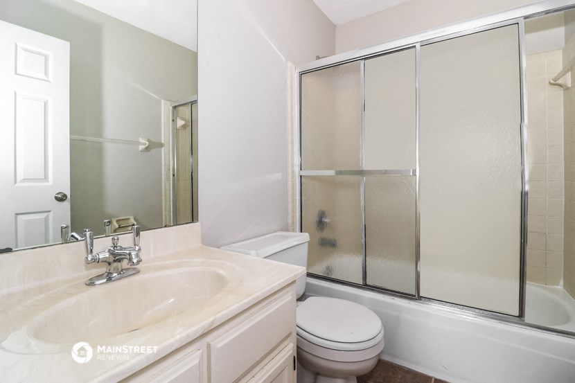 a bathroom with a sink toilet and a shower
