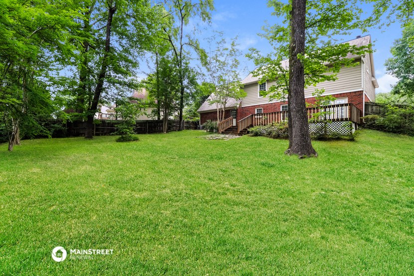 a large yard with a house in the background