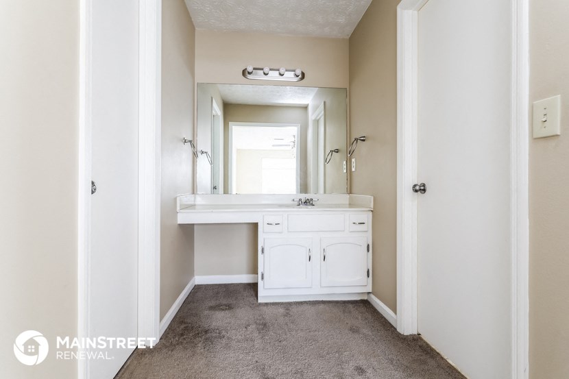 a white bathroom with a sink and a mirror