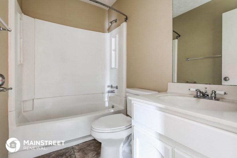 a bathroom with a sink toilet and a tub
