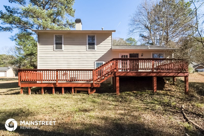 the back of a house with a wooden deck