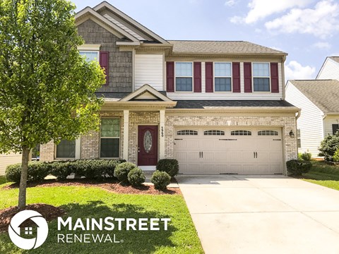 a house with a driveway and a garage door in front of it