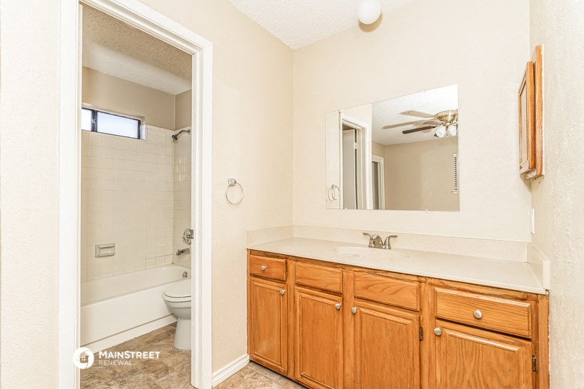 a bathroom with a mirror and a sink and a toilet
