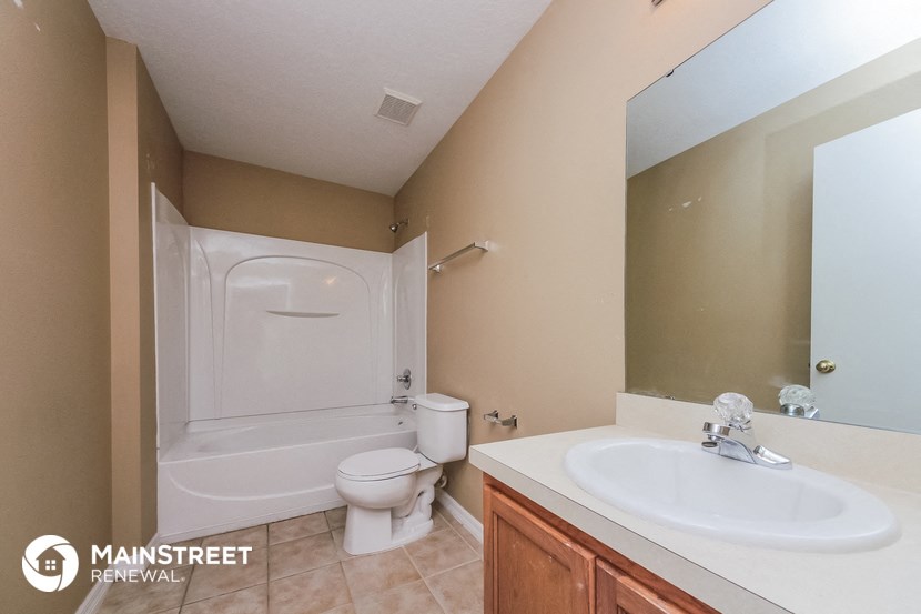 a bathroom with a sink and a toilet and a bath tub