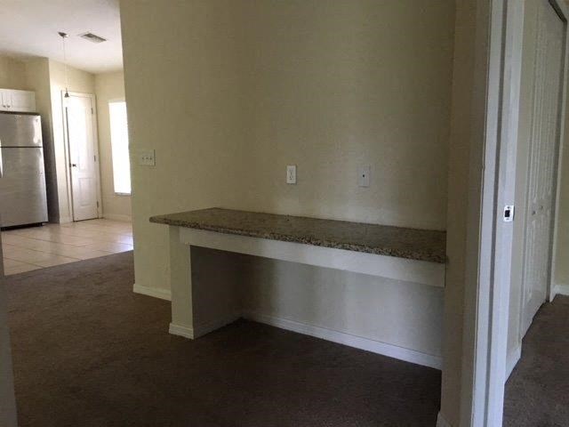 an empty living room with a counter in it