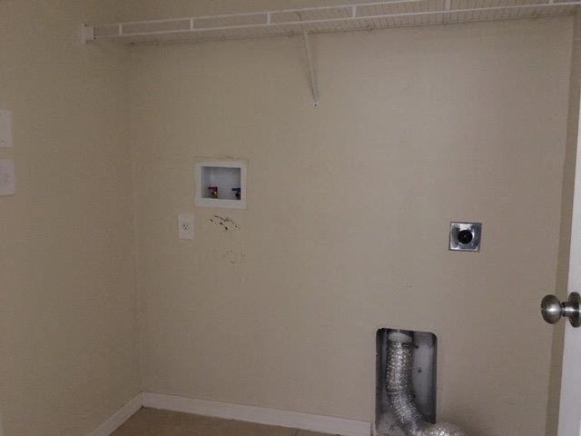 a bathroom with a urinal and a wall with a door