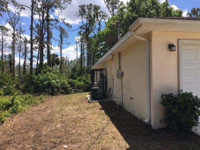 a small white house with a yard and a white door
