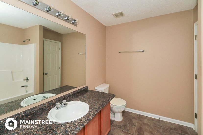 a bathroom with a sink and a toilet and a mirror