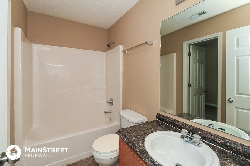 a bathroom with a sink toilet and a shower