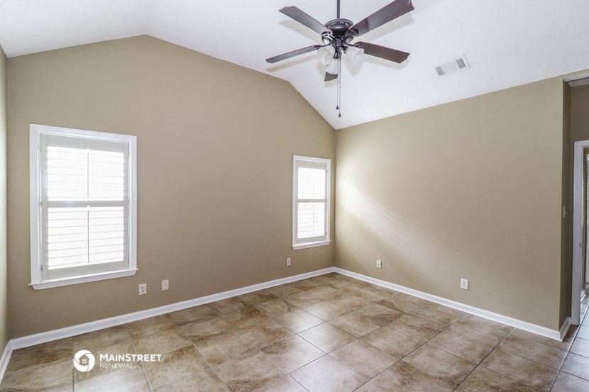 the living room of a home with a ceiling fan