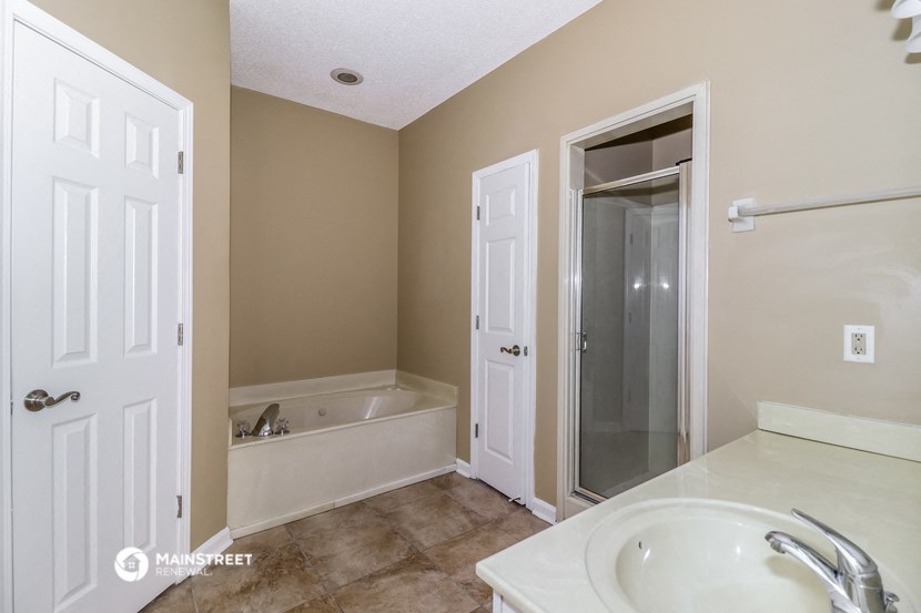 a bathroom with a sink and a tub and a shower