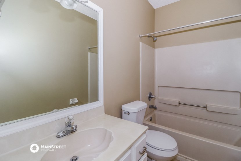 a bathroom with a sink and a toilet and a mirror