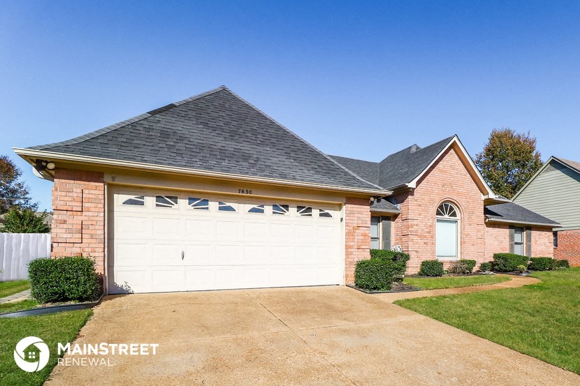a brick house with a white garage door
