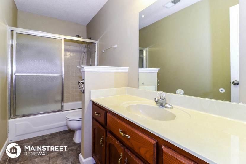 a bathroom with a sink and a shower and a toilet